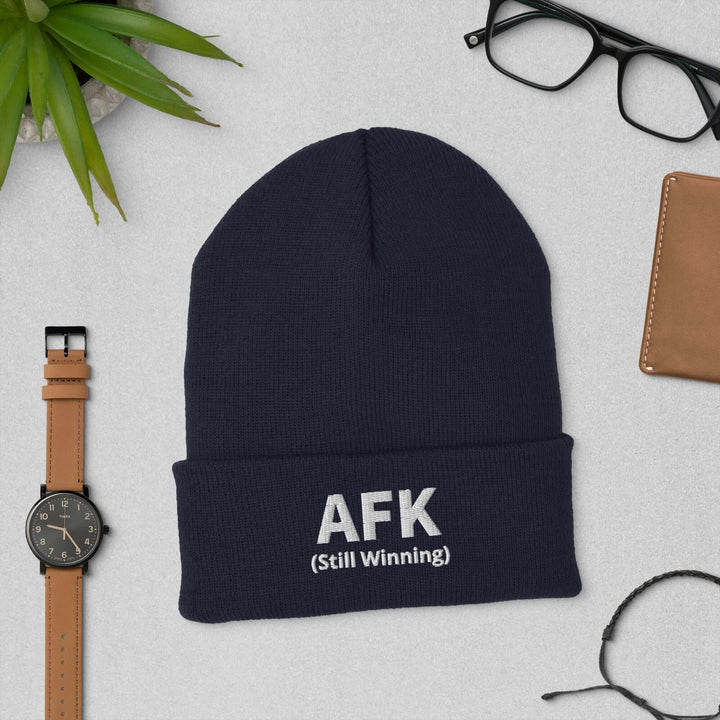AFK Cuffed Beanie displayed on a table with accessories including a watch, glasses, and a wallet.