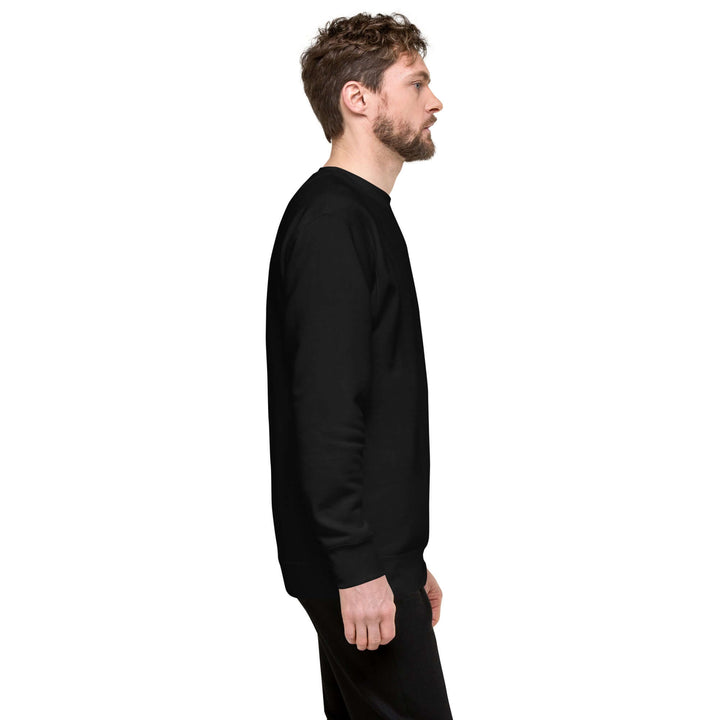 Profile view of a man wearing an Earthlets Unisex Premium Sweatshirt in black, showcasing its relaxed fit.