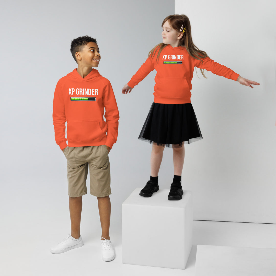 Two children wearing XP Grinder Kids eco hoodie, one in orange hoodie and shorts, other in skirt, showcasing eco-friendly fashion.