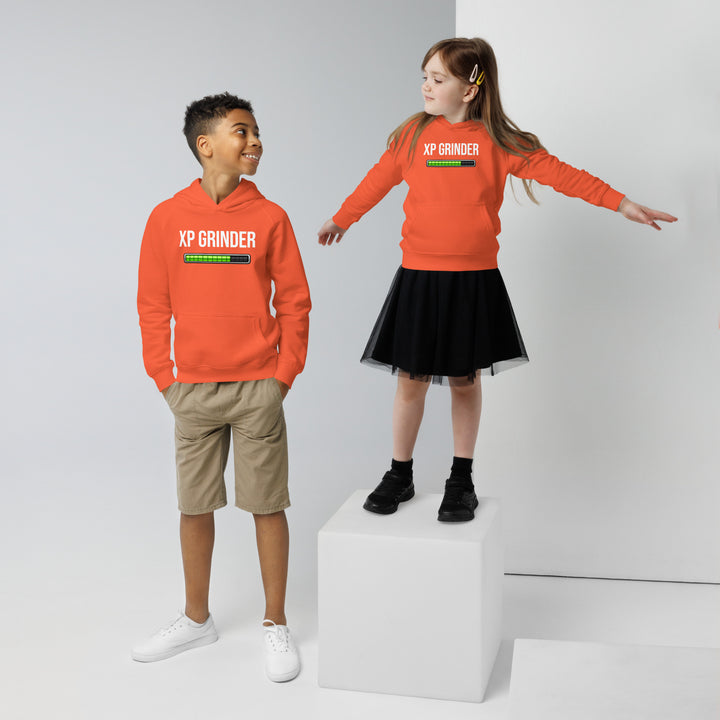 Two children wearing XP Grinder Kids eco hoodie, one in orange hoodie and shorts, other in skirt, showcasing eco-friendly fashion.