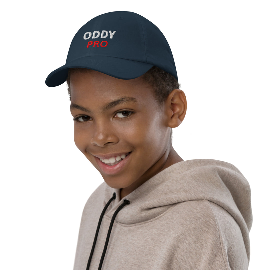 Oddy Pro Youth baseball cap worn by a smiling boy with a hoodie, showcasing comfort and style.
