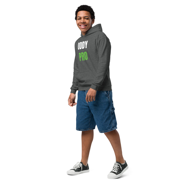 Boy wearing Oddy Pro Youth heavy blend hoodie with denim shorts, showcasing comfort and style.