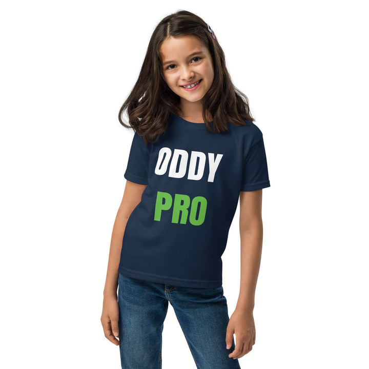 Girl wearing Oddy Pro Youth t-shirt in navy blue with bold white and green lettering.